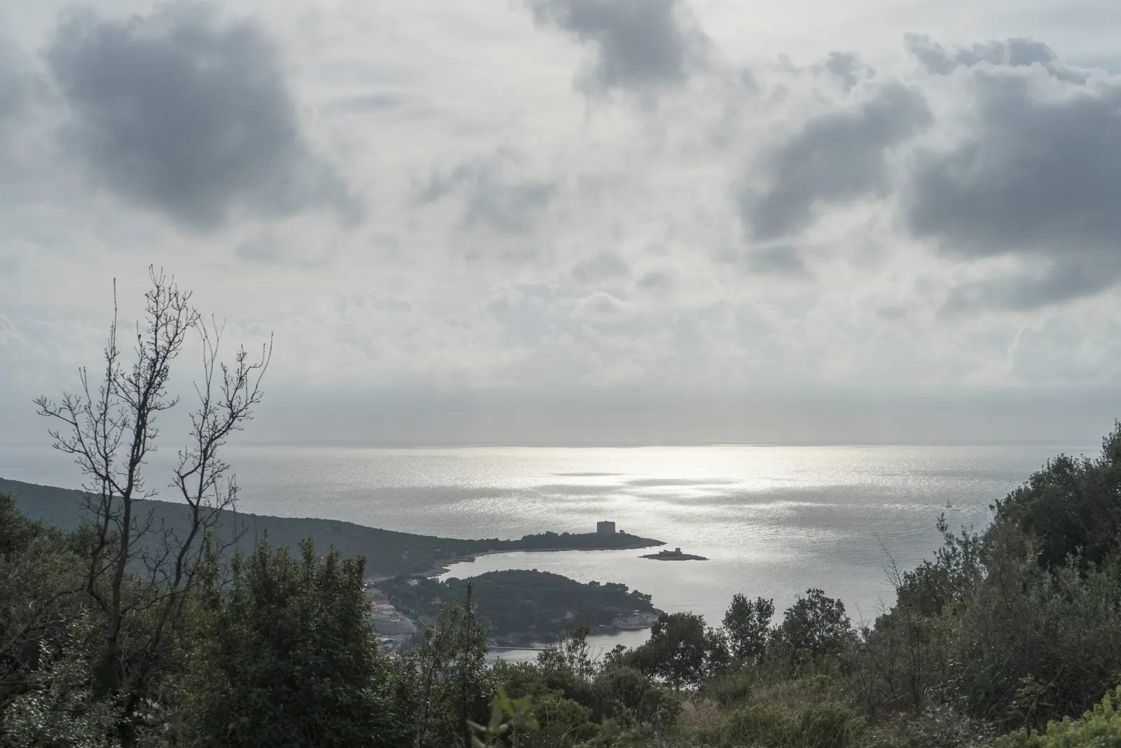 The Luštica peninsula seen from the Tići hamlet, its low green headlands closing off the open-sea mouth of the Bay of Kotor
