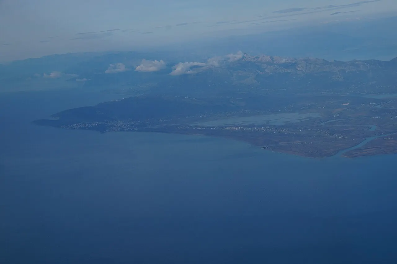 Aerial view of Montenegro's far south: the Ulcinj coast, salt flats and the reedy mouth of the Bojana river by Ada Bojana