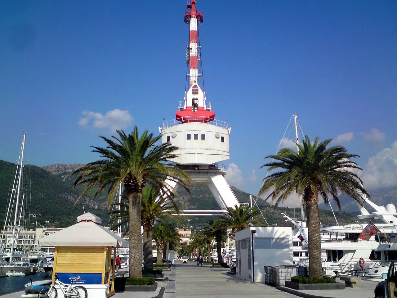 The Porto Montenegro marina at Tivat, yachts moored beside modern waterfront buildings with mountains rising behind