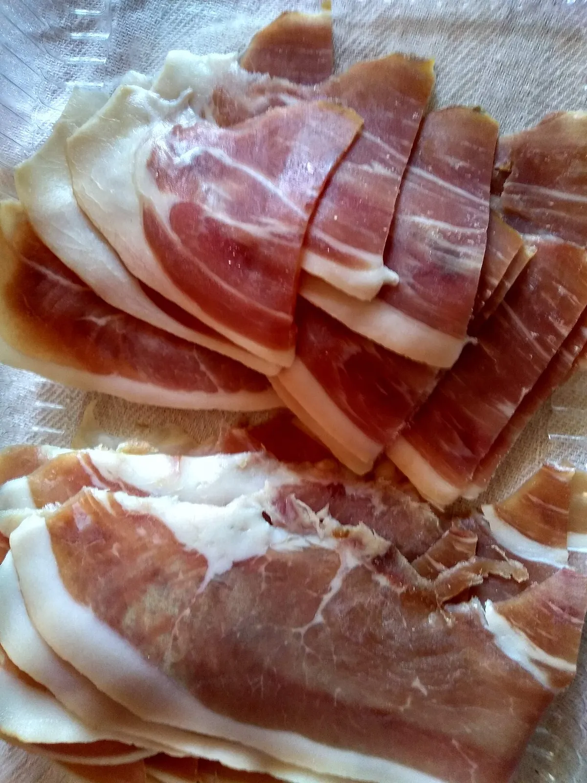 Sliced Njeguški pršut (Montenegrin prosciutto) arranged on a plate