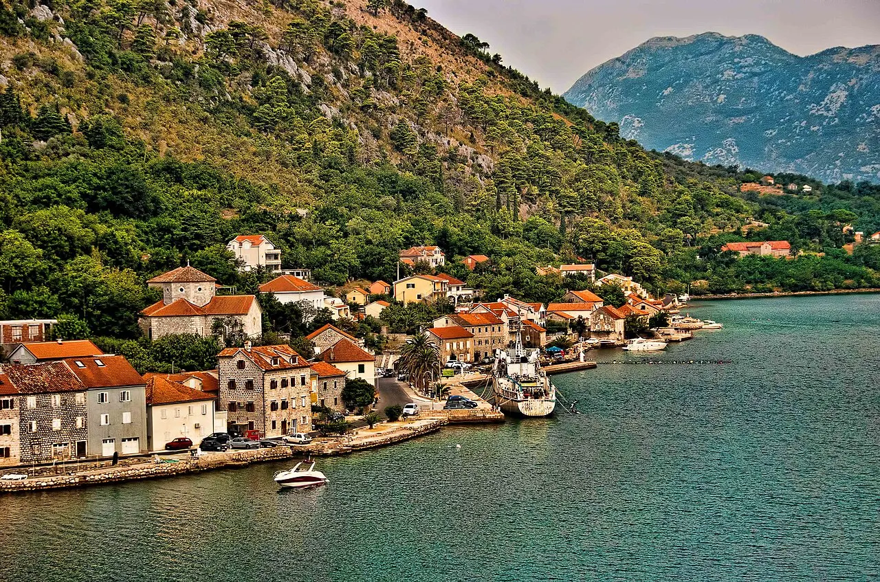 The clear, calm bay water along the Dobrota waterfront on the Bay of Kotor, a sheltered local swimming spot