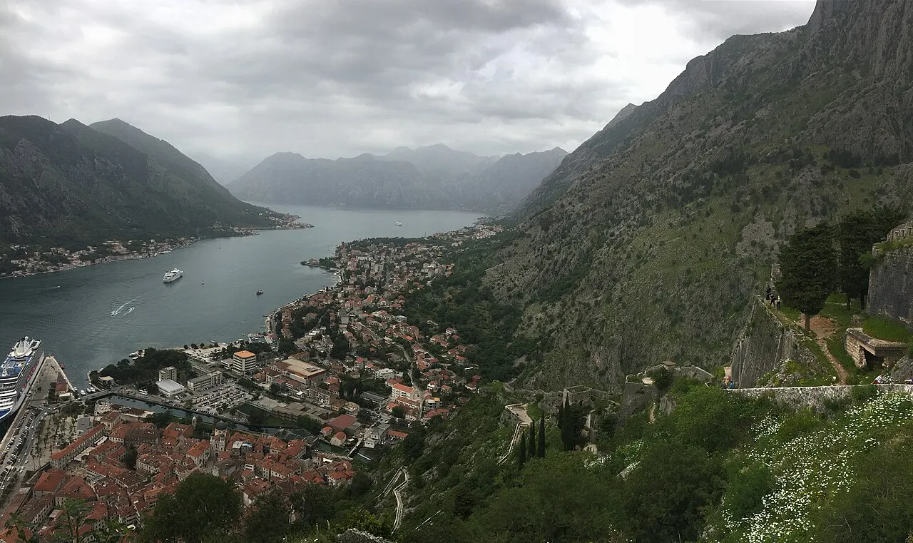 Kotor's fortress walls climbing the cliff above the Old Town, the bay stretching beyond