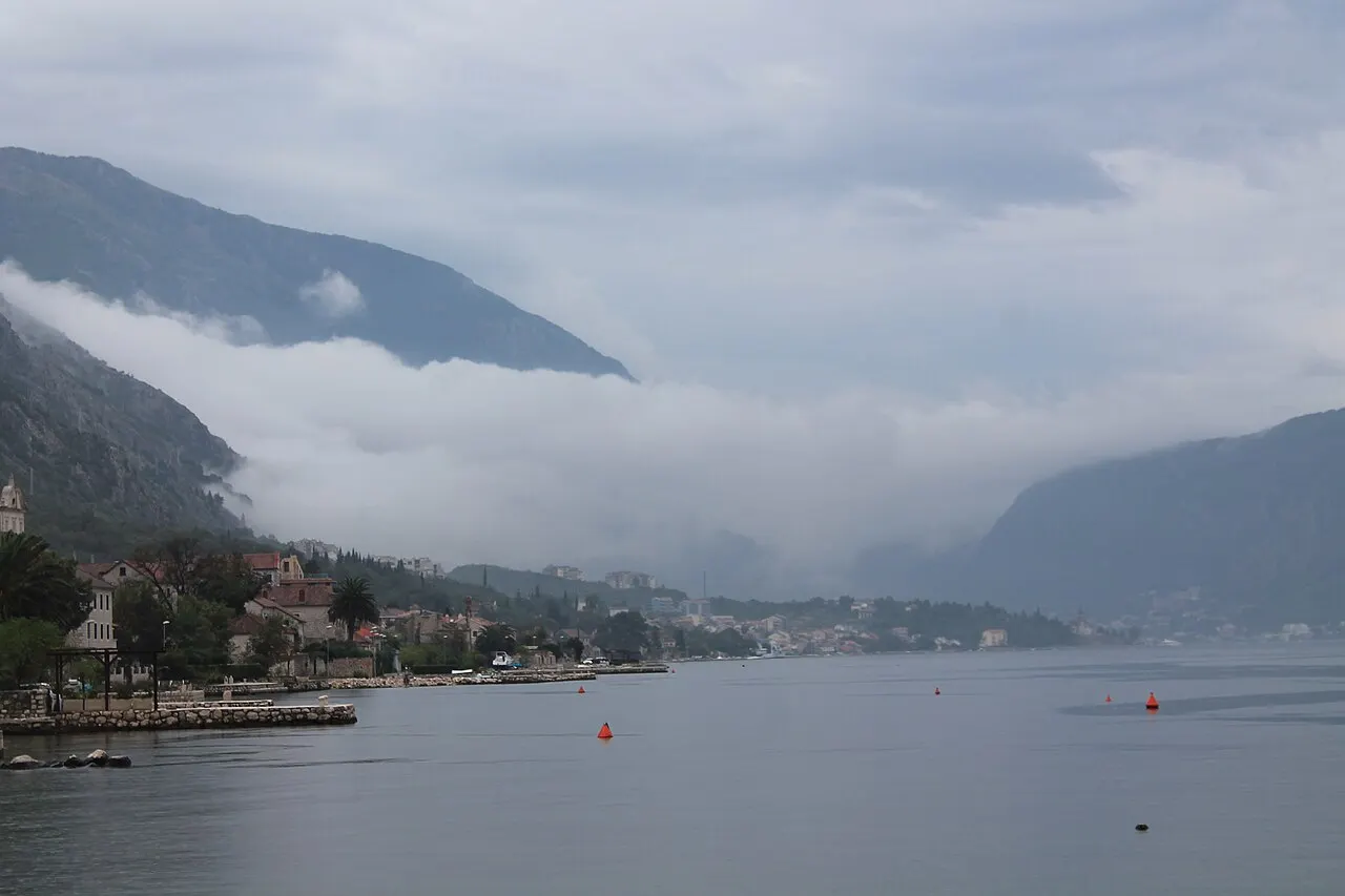 Flat waterfront along the Bay of Kotor at Dobrota looking across the bay to the mountains