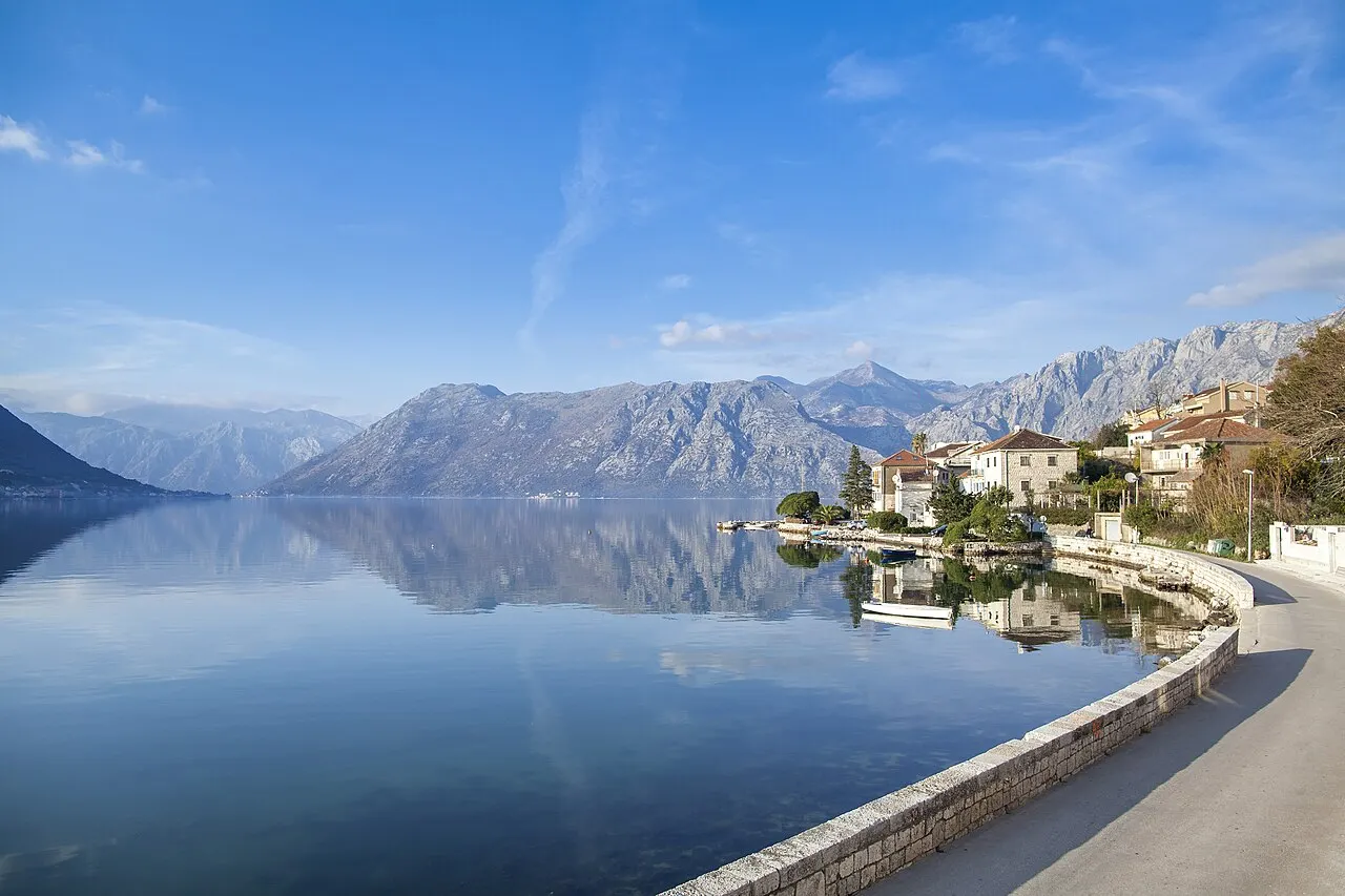A waterfront resort terrace overlooking the calm Bay of Kotor at Dobrota