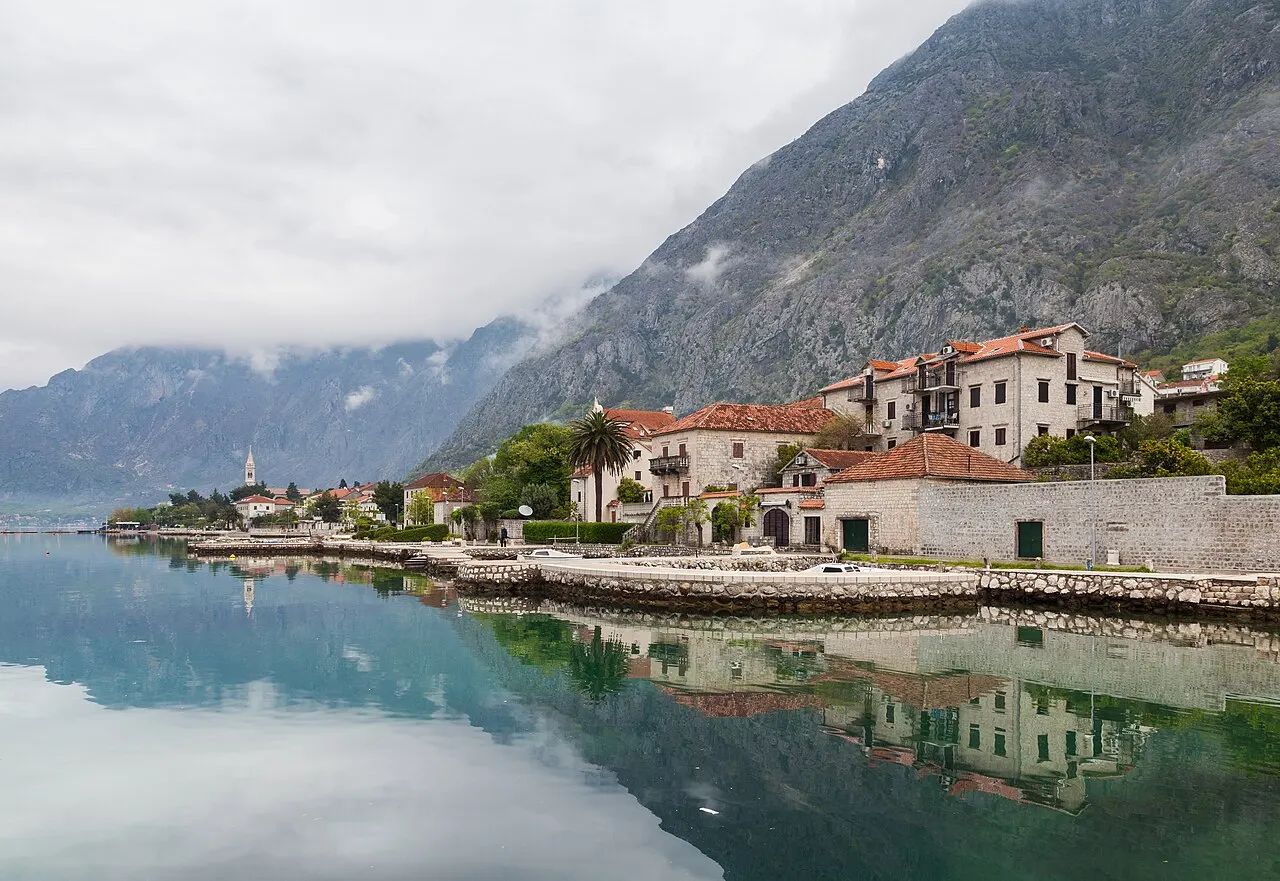 The calm Bay of Kotor at Dobrota, mountains mirrored in still water