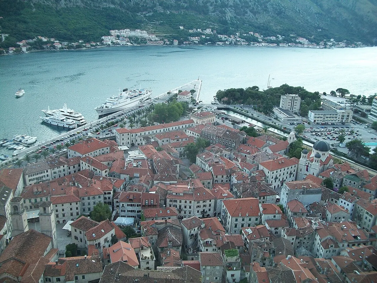Kotor Old Town's terracotta rooftops seen from the fortress trail, the bay beyond