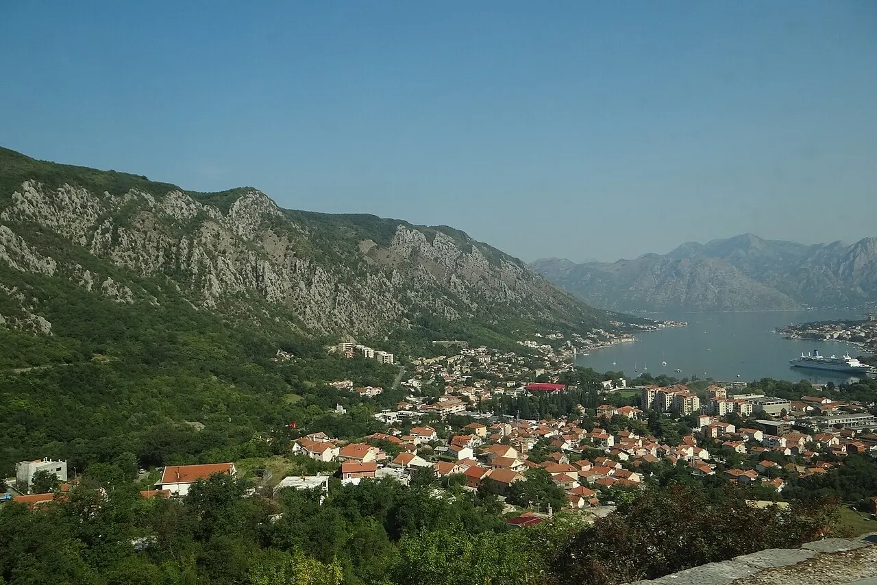 Green spring hills above the Bay of Kotor with the town and rooftops below