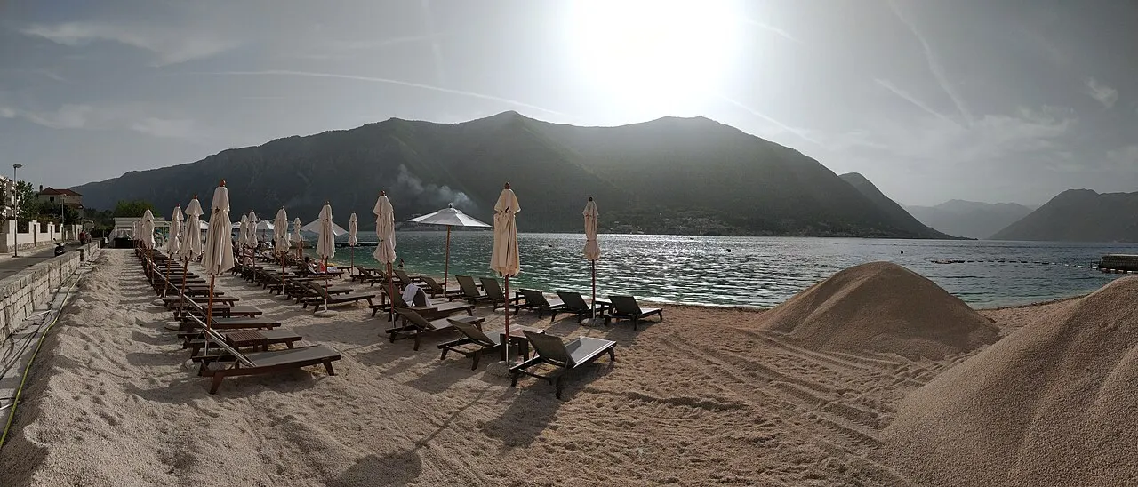 A swimming beach on the calm Bay of Kotor in front of the Dobrota palazzi