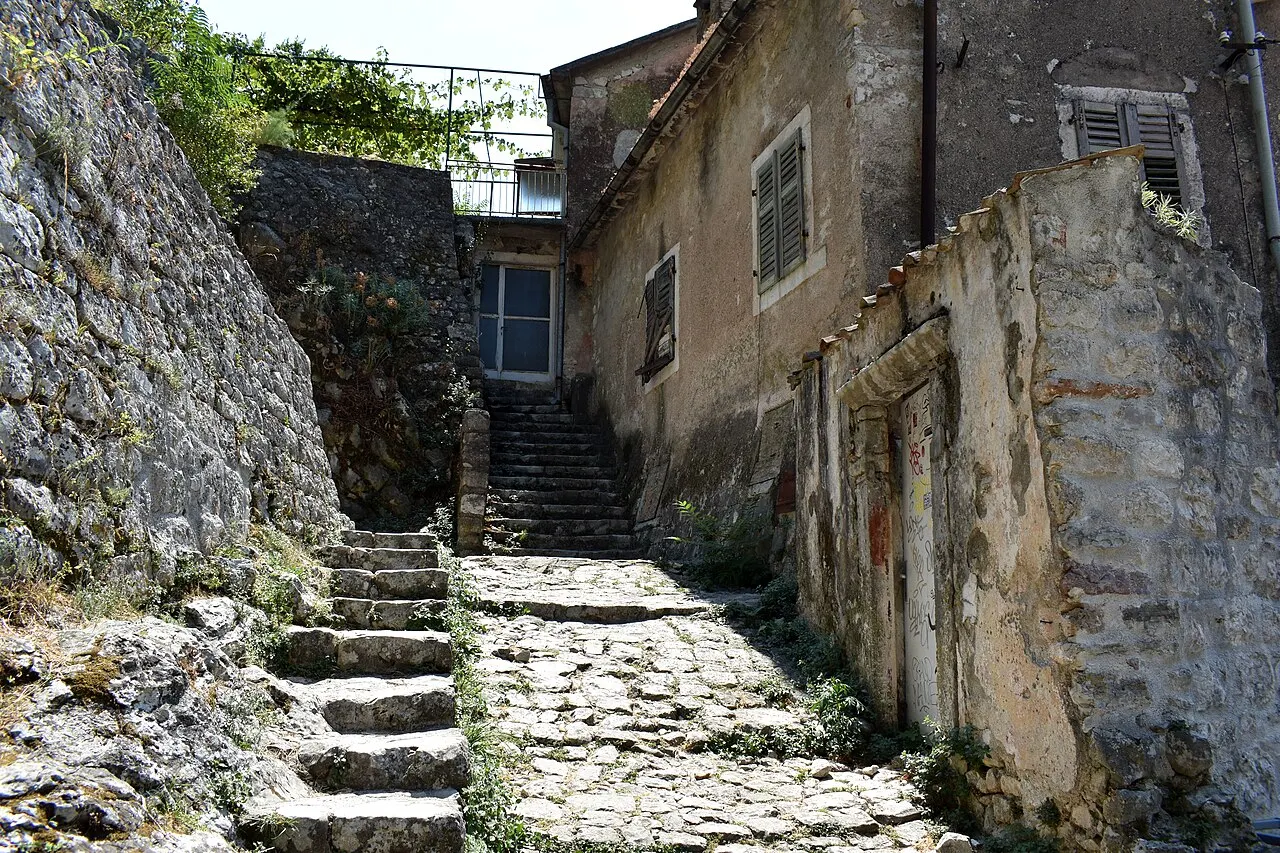 A narrow cobbled stone staircase climbing between historic buildings in Kotor Old Town