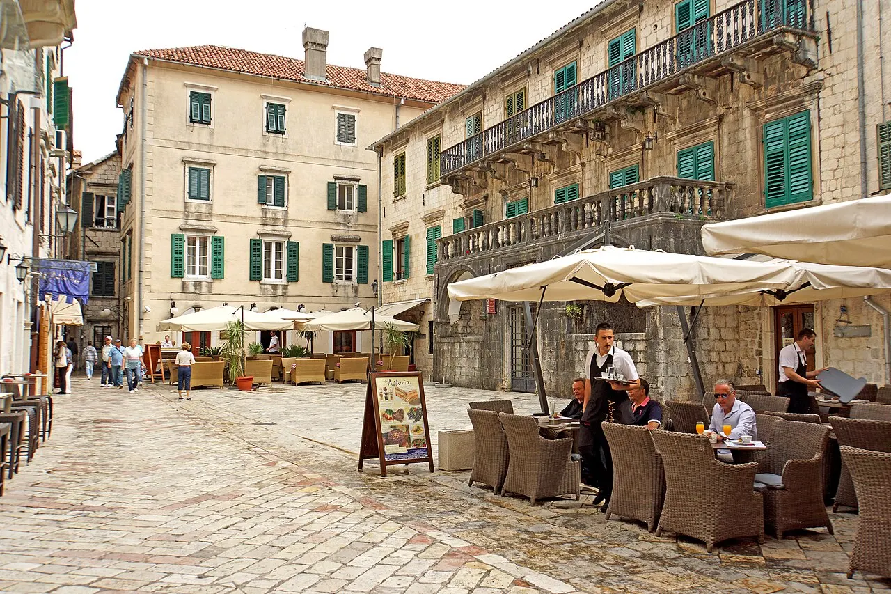 Cafe tables and umbrellas on Flour Square in Kotor's Old Town