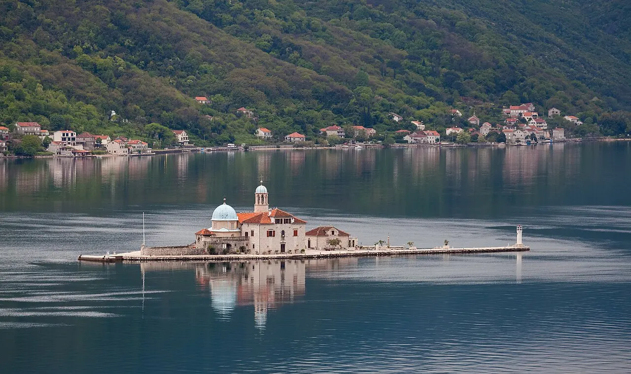 Our Lady of the Rocks church on its man-made islet, the Bay of Kotor mountains rising behind
