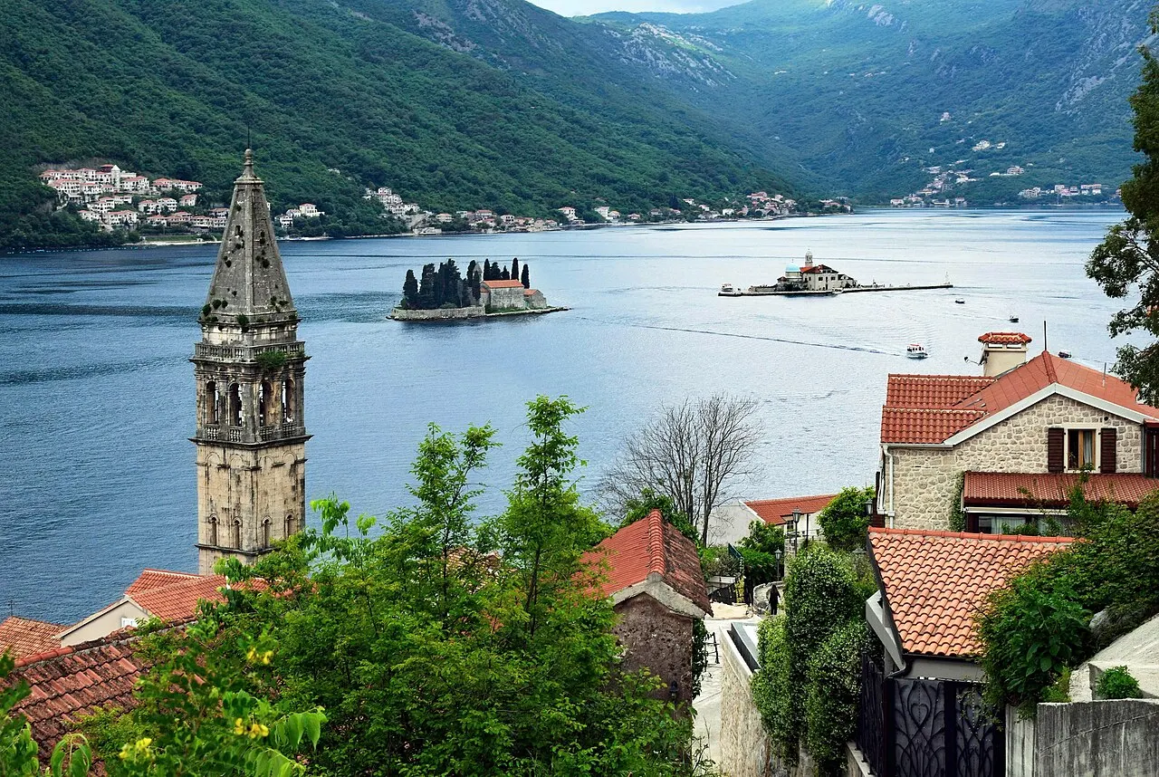 St Nicholas bell tower above Perast rooftops with the two islets out on the Bay of Kotor