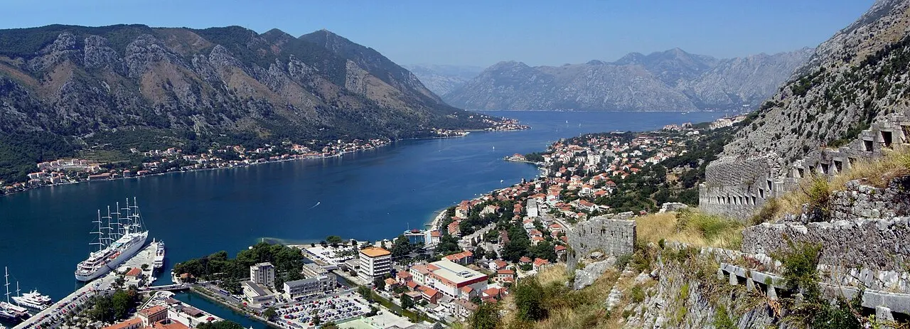 Panorama of Kotor and the Bay of Kotor seen from partway up the city walls, the inner bay stretching between mountains