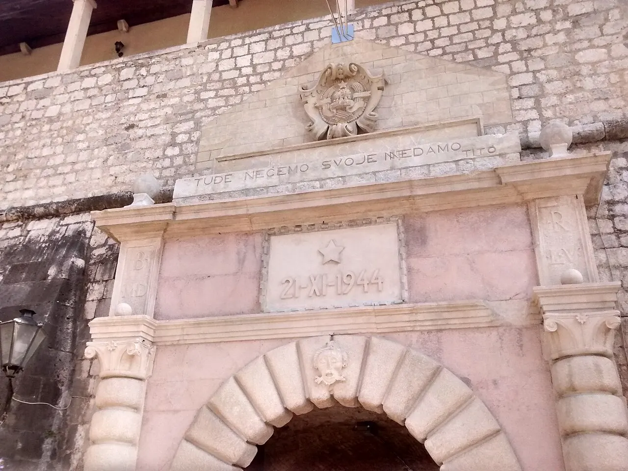 The Sea Gate entrance to Kotor's Old Town, the city walls rising behind