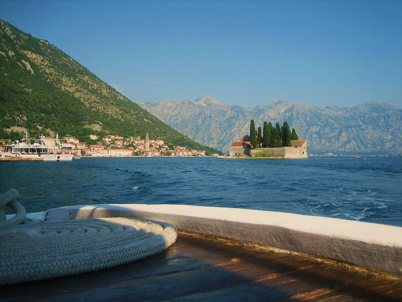 Perast and the islet of Sveti Đorđe seen from a boat on the still Bay of Kotor