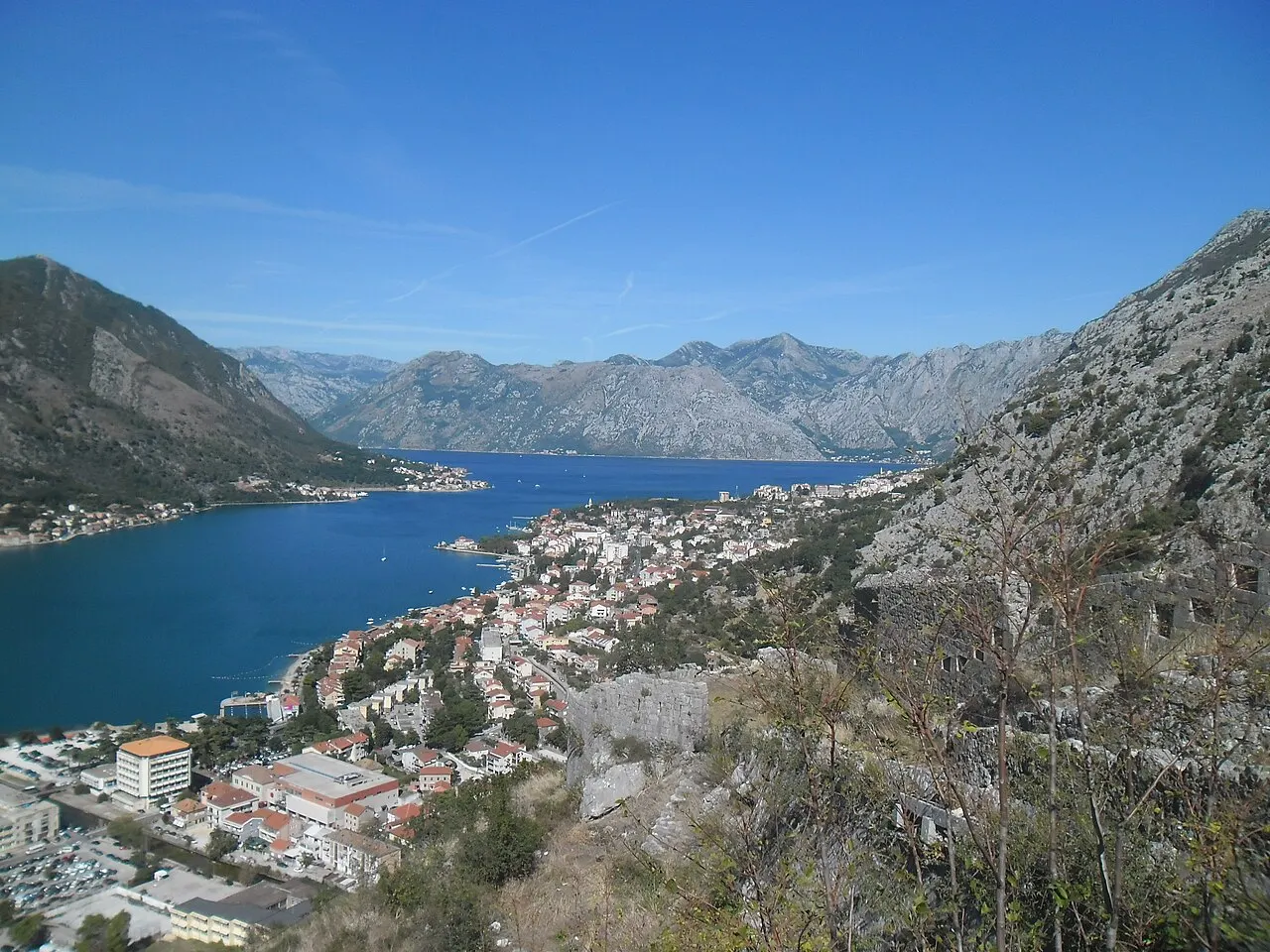 The Kotor waterfront and bay with mountains beyond in warm afternoon light