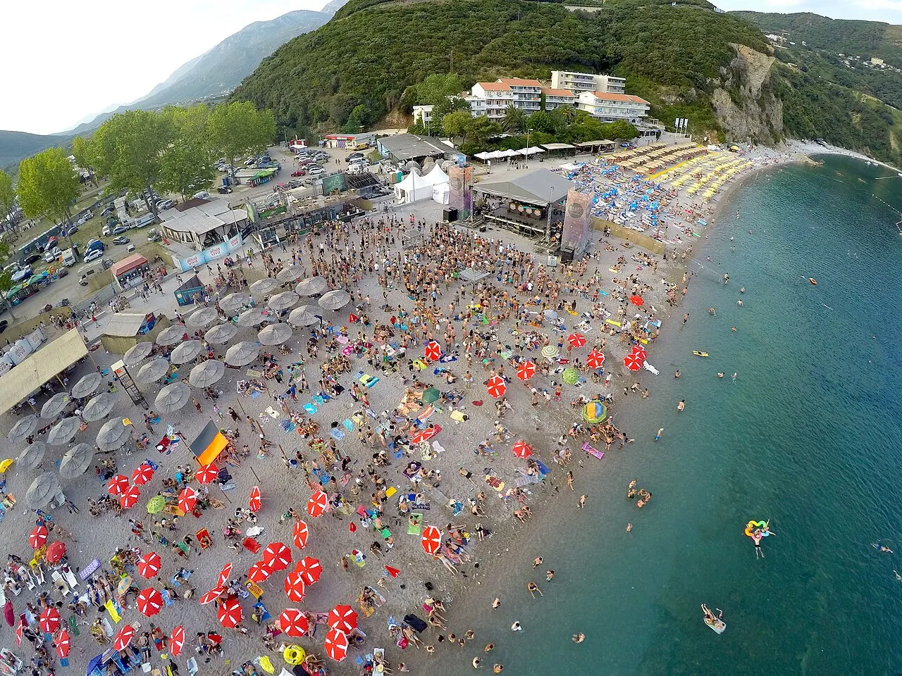 Crowds packing the beach before the Sea Dance Festival stage on the Montenegro coast, the Adriatic beyond
