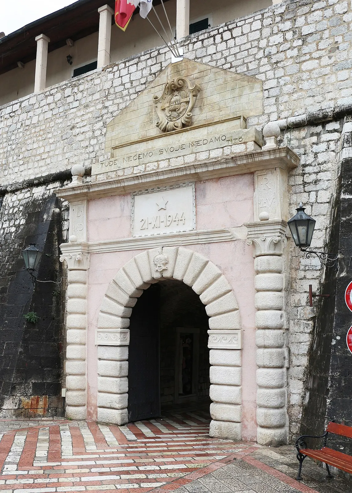The stone arch of the Sea Gate in Kotor's western wall, carved relief and inscription above the entrance