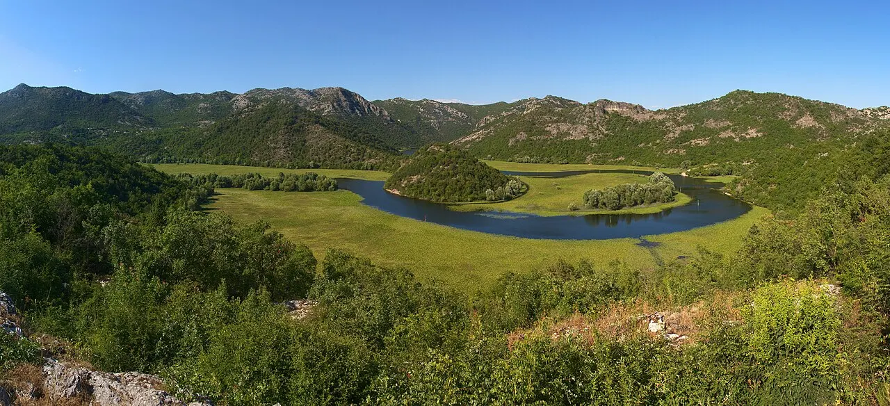 The horseshoe bend of the Rijeka Crnojevića river looping below a hillside near Skadar Lake, Montenegro