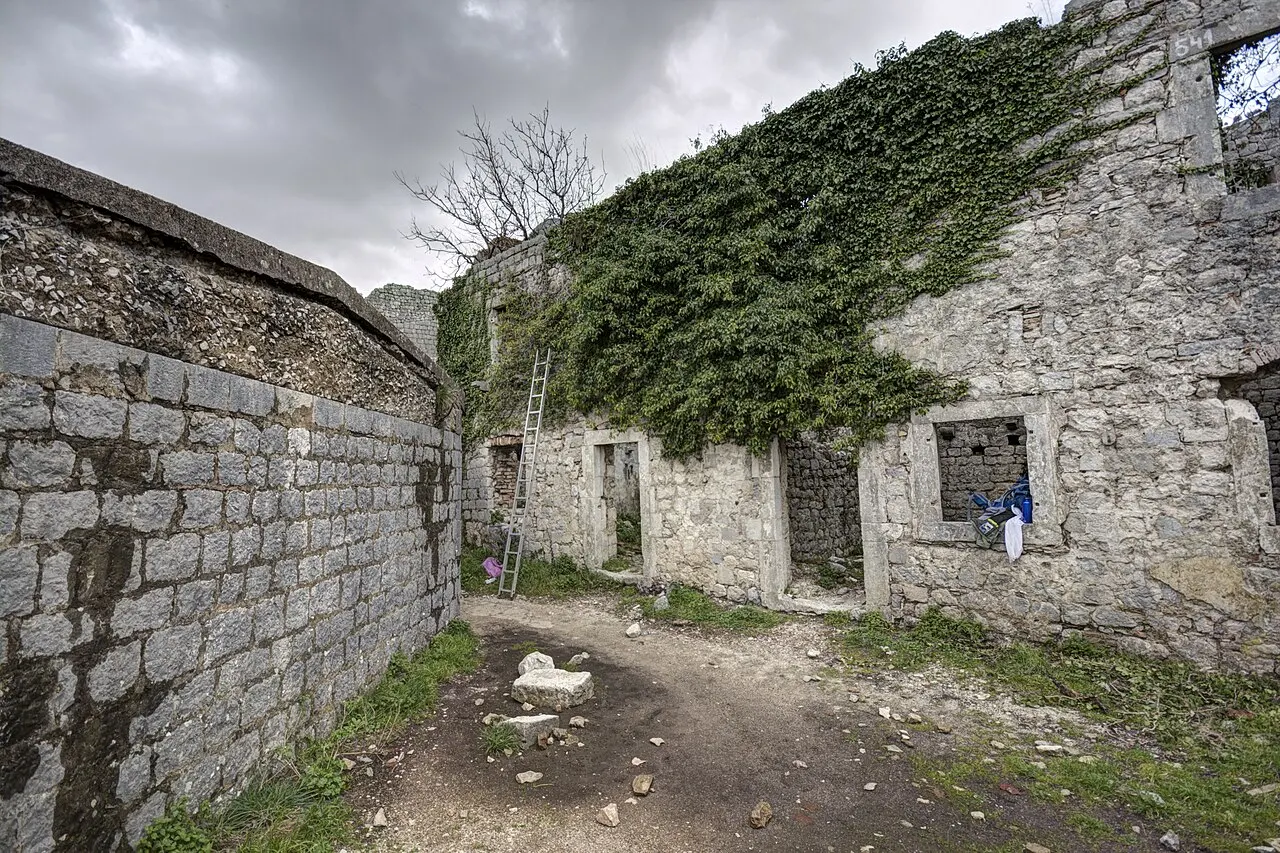 The upper ramparts and ruined stonework of St John Fortress on the ridge high above Kotor
