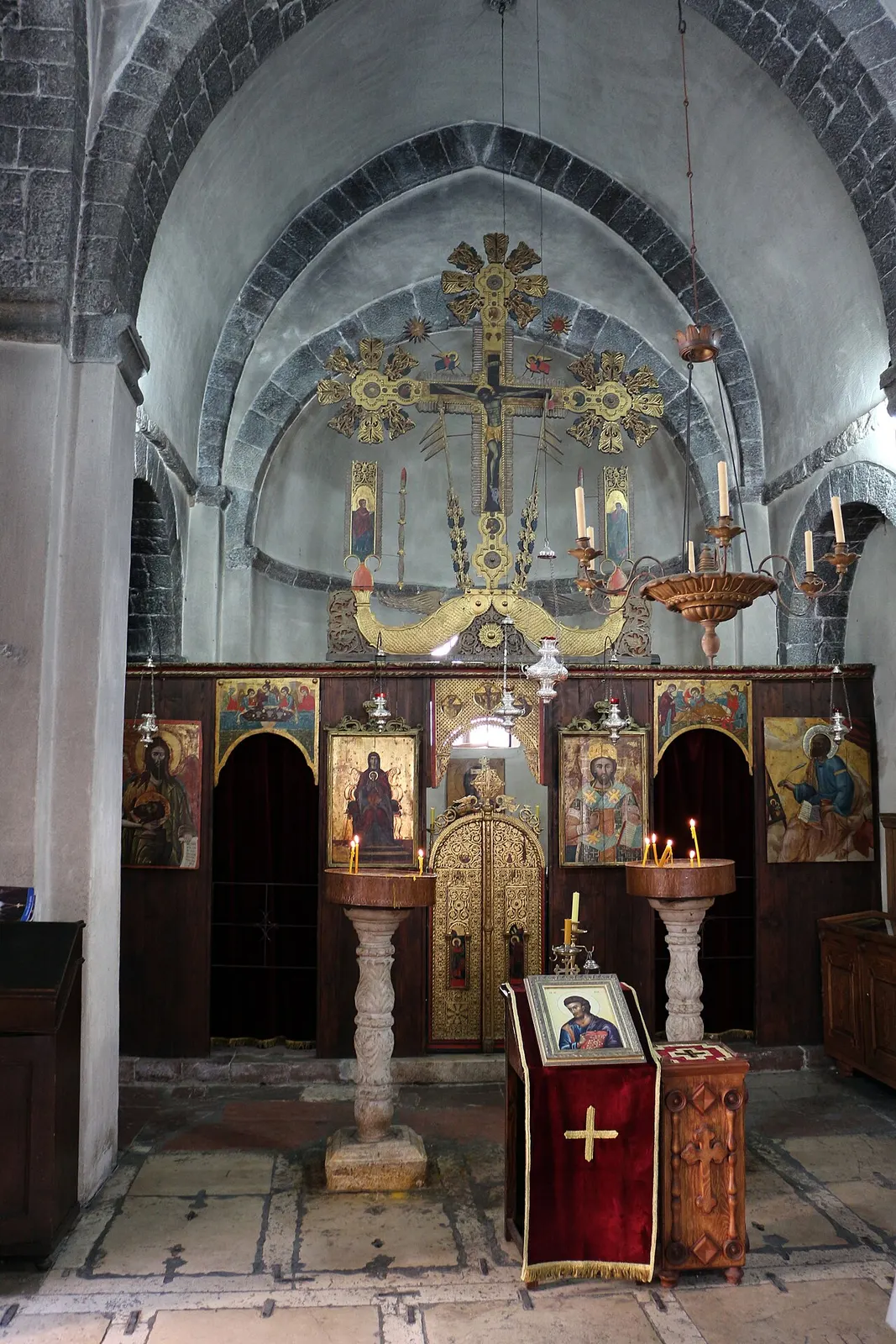The 17th-century iconostasis and icons inside St Luke's Church, against its old stone vaults in Kotor